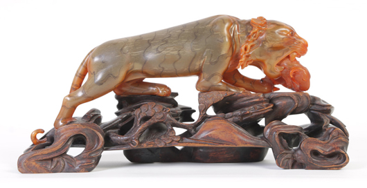 Lot 1 - rare rhinoceros horn carving depicting a tiger with captured prey. Kamelot Auction House image.
